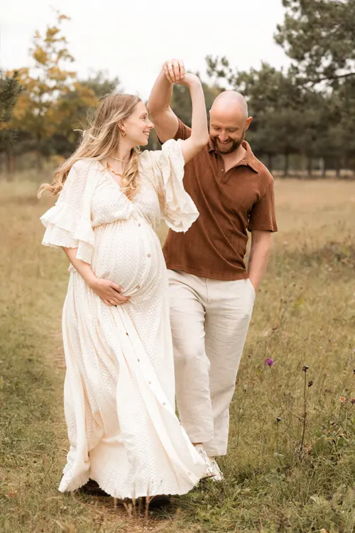 Paar geht im Schwangerschaftsshooting im Park spazieren